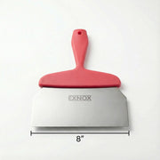 Red spatula with metal blade and 'EXNOX' branding on a white background