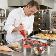 Chef preparing dessert in a professional kitchen